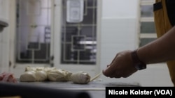 "Si tu ne fais pas de cachitos, tu n'es pas boulanger": Luis Salcedo, de sa boulangerie à Caracas, en préparant ce petit pain à la pâte mi-sucrée.