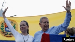 Le candidat de l'opposition à la présidentielle, Edmundo González, salue ses partisans lors d'un événement politique, à Guatire, Miranda, en compagnie de la leader María Corina Machado.  Selon les analystes, Machado sera décisif pour l’anti-chavisme lors des élections de juillet.