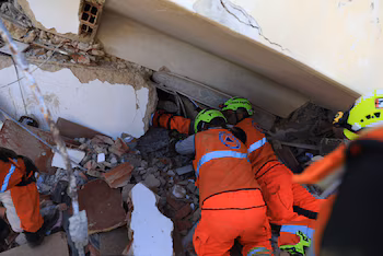 Des sauveteurs panaméens travaillent dans un bâtiment effondré à La Guaira